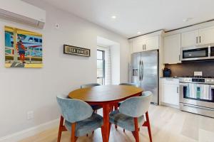 a kitchen with a wooden table and four chairs at Fun in the Sun in Provincetown +20 photos