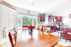 a kitchen with a table with a vase of flowers on it at Main Street Upper in Vineyard Haven