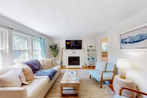 a living room with a couch and a fireplace at Downtown Seaside Serenity Retreat in Hyannis