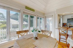 a dining room with a table and some windows at Shoreline Escape in Mashpee +23 photos