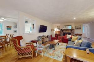 a living room with a couch and a table at Tall Pines in Wellfleet