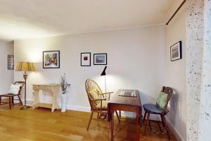 a living room with a table and chairs and a desk at Tall Pines in Wellfleet