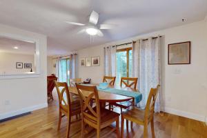 a dining room with a table and chairs at Tall Pines in Wellfleet