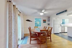 a kitchen and dining room with a table and chairs at Tall Pines in Wellfleet