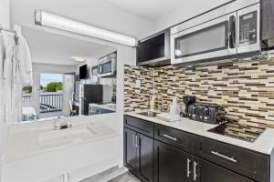 a kitchen with a sink and a microwave at Studio 6 Wilmington, NC in Wilmington +45 photos