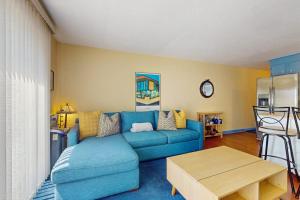 a living room with a blue couch and a table at The Blue Cottage in Provincetown