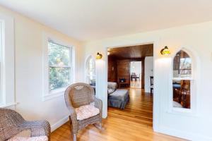 a living room with two chairs and a couch at Belmont Beach Cottage in West Harwich