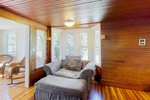 a living room with a couch and a chair at Belmont Beach Cottage in West Harwich