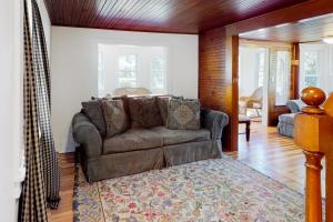a living room with a couch and a rug at Belmont Beach Cottage in West Harwich +15 photos