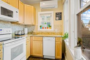 a kitchen with white appliances and a window at Lady Burns' Lookout in Provincetown