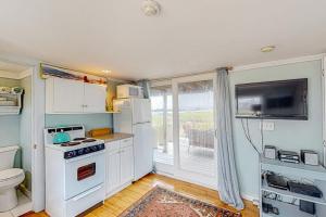 a kitchen with a white stove and a sink at Bayview Escape in Provincetown