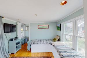 a living room with a couch and a window at Bayview Escape in Provincetown
