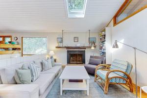 a living room with a couch and a fireplace at Drummer Cove Retreat in Wellfleet