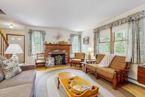 a living room with a couch and a fireplace at Sandpiper's Saltbox in Dennis