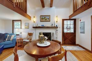 a living room with a table and a fireplace at The Lodge in Provincetown