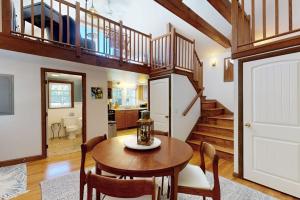 a dining room with a table and a staircase at The Lodge in Provincetown