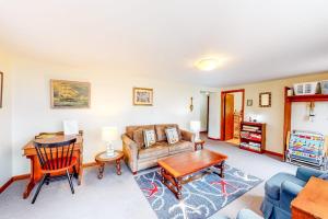 a living room with a couch and a table at Nauset Beach Getaway in Orleans