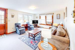 a living room with a couch and a table at Nauset Beach Getaway in Orleans