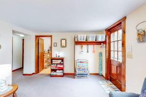 a living room with a shelf and a door at Nauset Beach Getaway in Orleans +42 photos