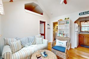 a living room with a couch and a table at Cozy Escape on the Cape in Eastham