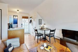 a living room with a table and chairs and a kitchen at The Buoy Room in Provincetown