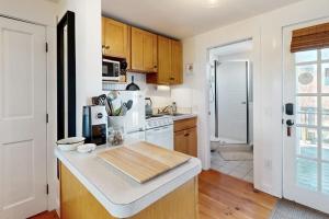 a kitchen with wooden cabinets and a counter top at The Buoy Room in Provincetown