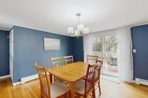 a dining room with a wooden table and chairs at Captain's Escape in South Yarmouth