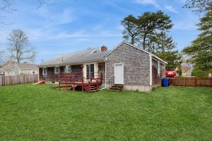 a small house in a yard with a fence at Captain's Escape in South Yarmouth