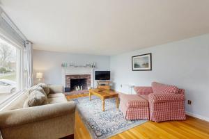 a living room with two couches and a fireplace at Captain's Escape in South Yarmouth