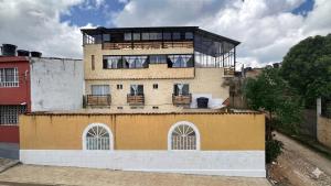 a building with a balcony on top of it at Hotel Casa Palma in La Mesa