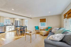 a living room with a couch and a table at Seabreeze Escape in Falmouth