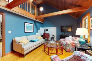 a living room with a white couch and a table at Need a Bigger Boat in Edgartown