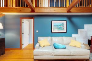 a living room with a white couch and a blue wall at Need a Bigger Boat in Edgartown