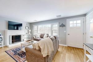 a living room with a couch and a fireplace at Champagne Dreams in Dennis
