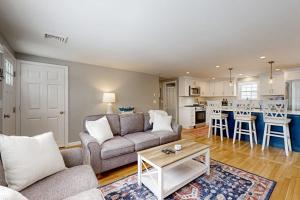 a living room with a couch and a table at Champagne Dreams in Dennis