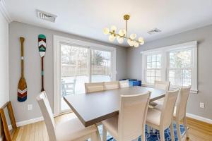a dining room with a table and chairs at Champagne Dreams in Dennis