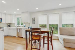 a kitchen with a table and chairs and a couch at The Saffron Cottage in Wellfleet