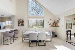 a dining room with a white table and chairs at Twin Ponds in Oak Bluffs