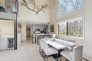 a kitchen and dining room with a table and chairs at Twin Ponds in Oak Bluffs