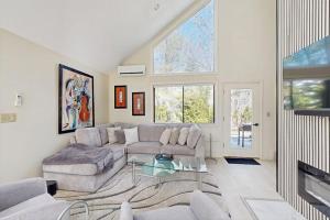 a living room with a couch and a table at Twin Ponds in Oak Bluffs +24 photos