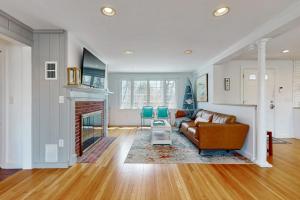 a living room with a couch and a fireplace at Cape Bliss in Yarmouth