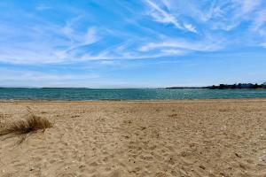 a sandy beach with the ocean in the background at Cape Bliss in Yarmouth
