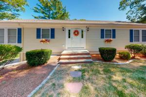 a house with a front door with a wreath on it at Osterville Odyssey in Osterville