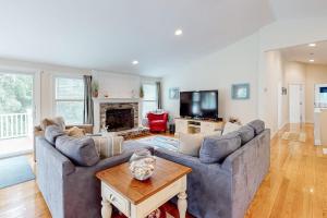a living room with a couch and a table at Osterville Odyssey in Osterville
