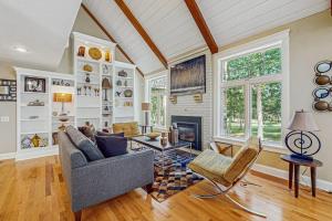 a living room with a couch and a fireplace at Sanctuary In The Woods in East Falmouth