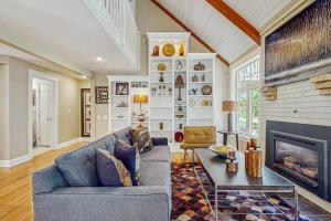 a living room with a couch and a fireplace at Sanctuary In The Woods in East Falmouth
