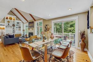 a living room with a table and chairs at Sanctuary In The Woods in East Falmouth