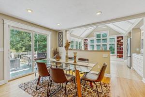 a kitchen and dining room with a table and chairs at Sanctuary In The Woods in East Falmouth