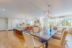 a kitchen and dining room with a table and chairs at Plum Paradise in Barnstable