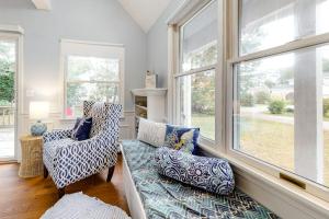 a living room with a couch and a window at Ferry Harbor Cottage in Falmouth